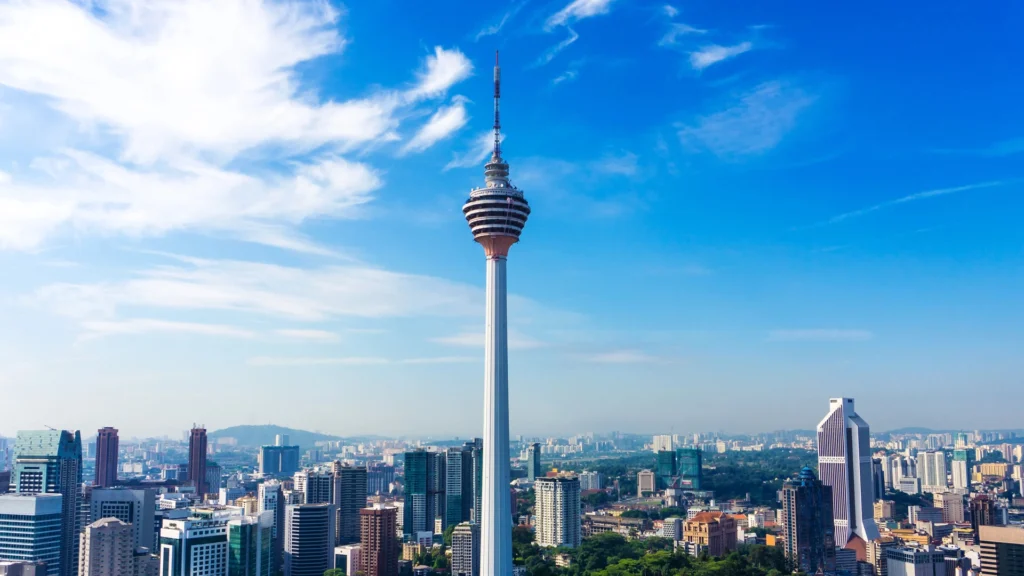 "Stunning view of Menara Kuala Lumpur (KL Tower) lit up at night in Malaysia"